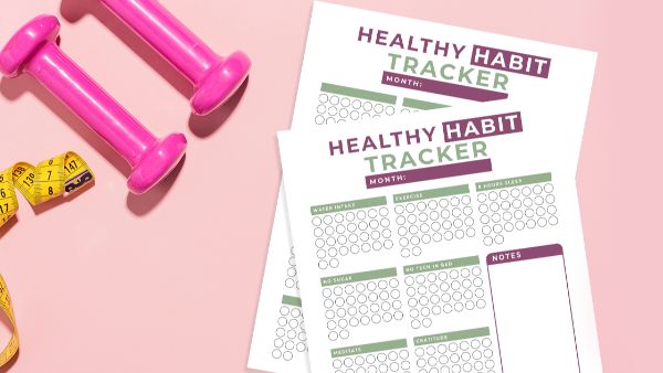 habit tracker printable on pink background with pink hand weights