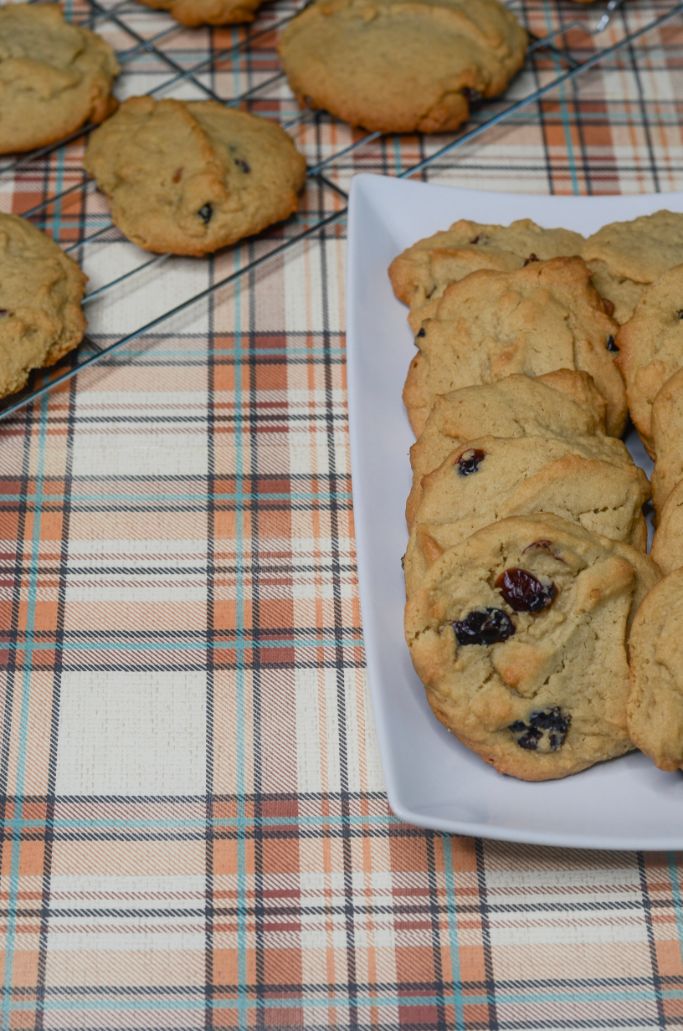 Cranberry Cookies on a wire cooling rack to the left and on a white plate to the right