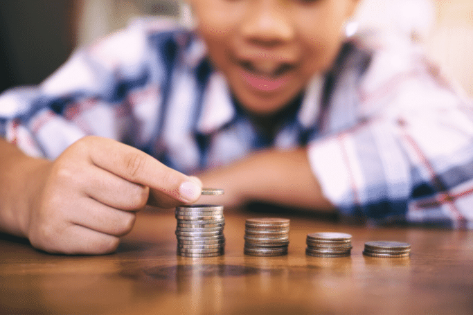 boy counting and stacking coins