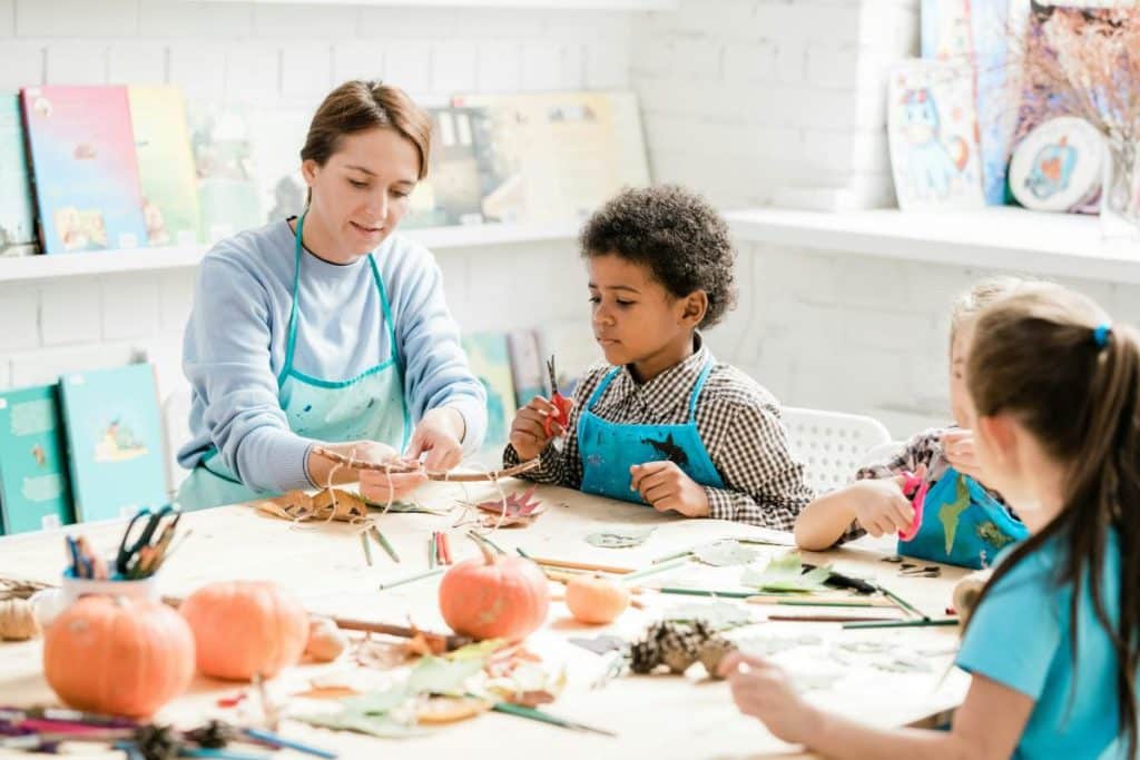 kids in an art class with their teacher